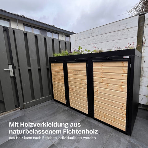 Mülltonnenbox aus naturbelassenem Fichtenholz von BIO Stefan mit Pflanzdach und schwarzem Rahmen.