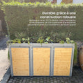 Abri pour poubelles en acier résistant aux intempéries, décoré de plantes, devant une haie verte.