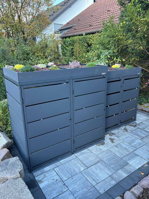 BIO Stefan Dagobert Mülltonnenbox 4er Kombination 120l und 240l in Anthrazit mit Pflanzdach, bepflanztes Dach mit blühenden Stauden und Sedum, über Eck auf Terrasse