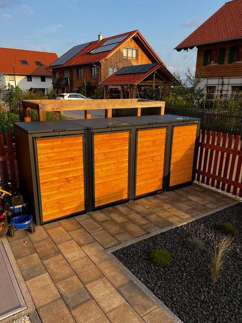 BIO Stefan Holzmichl Mülltonnenbox 4er 240l anthrazit mit Holzfront im gepflegten Garten vor Einfamilienhaus