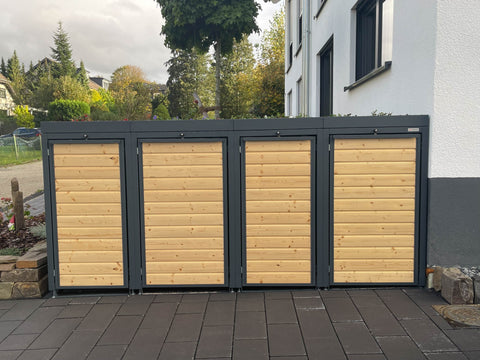BIO Stefan Holzmichl Mülltonnenbox 4er Kombination 120l 240l in Anthrazit mit Holzfront und bepflanztem Pflanzdach vor Hausfassade