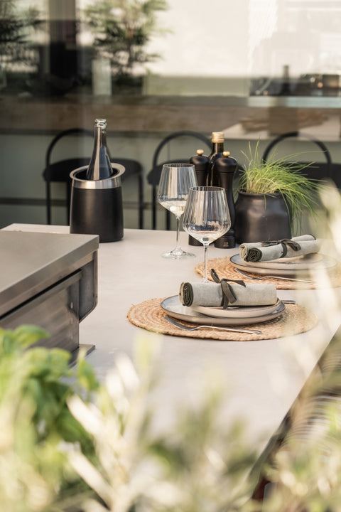 Outdoor kitchen as a cooking island with a bar counter: grill at the front, sit at the back